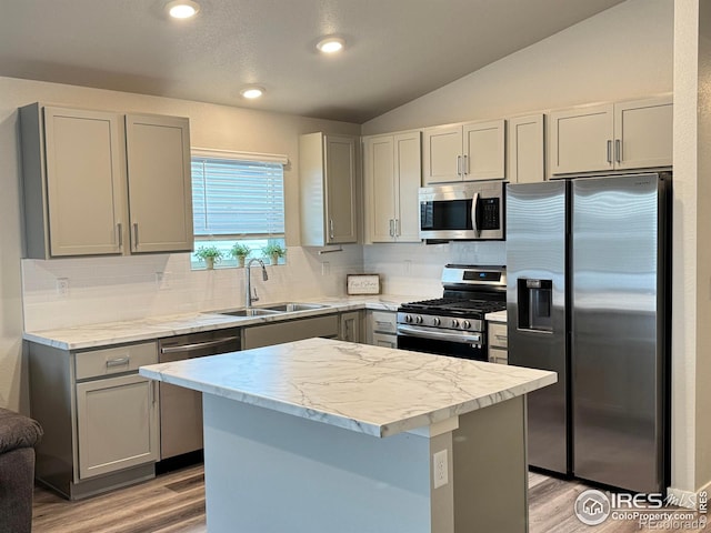 401 Bonneville Ave, Fort Lupton, CO 80621 - kitchen with appliances with stainless steel finishes, a sink, gray cabinets, light wood-style flooring, and a center island
