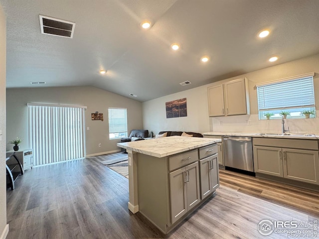 401 Bonneville Ave, Fort Lupton, CO 80621 - kitchen featuring stainless steel dishwasher, gray cabinets, open floor plan, a kitchen island, and lofted ceiling