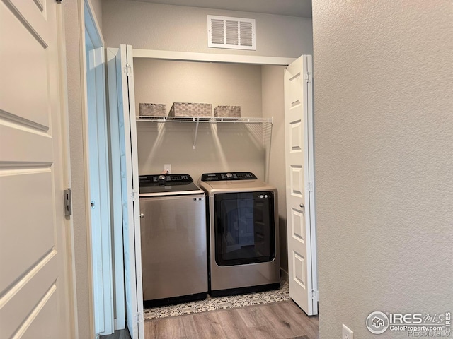 401 Bonneville Ave, Fort Lupton, CO 80621 - laundry room with washer and dryer, wood finished floors, and a textured wall