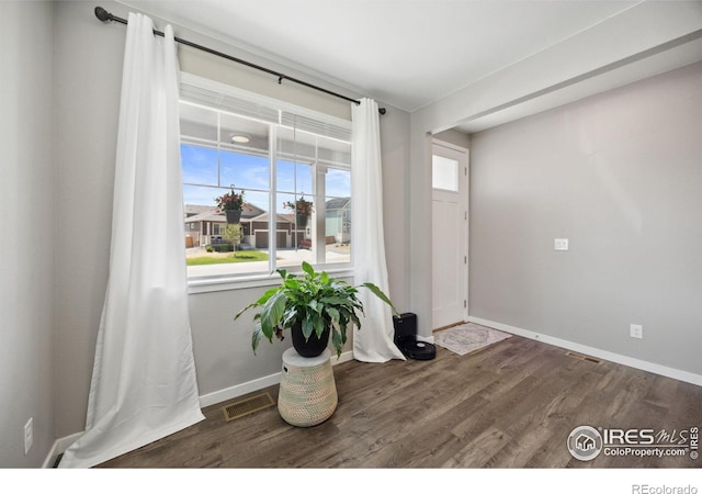 entrance foyer with wood finished floors and baseboards