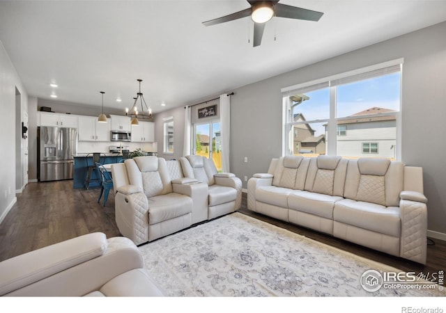 living room with dark wood finished floors, baseboards, plenty of natural light, and recessed lighting