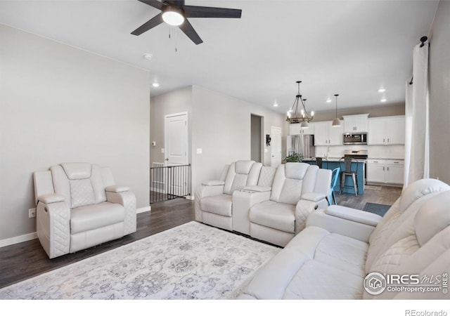 living room featuring recessed lighting, ceiling fan, dark wood-type flooring, and baseboards