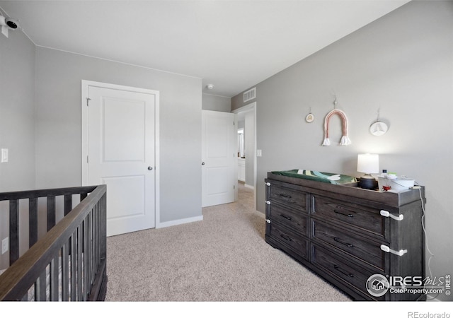 bedroom featuring carpet floors, baseboards, and a nursery area
