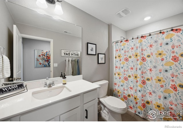 bathroom with toilet, vanity, tile patterned flooring, and a shower with shower curtain