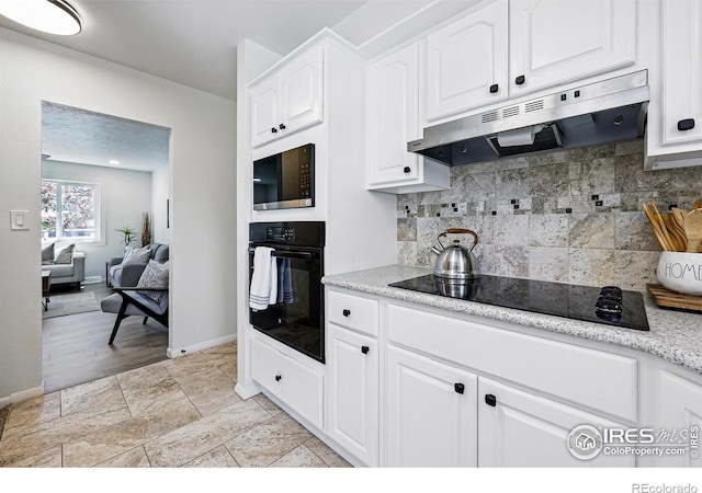 1805 W 22nd St, Loveland, CO 80538 - kitchen featuring black appliances, under cabinet range hood, white cabinets, backsplash, and baseboards