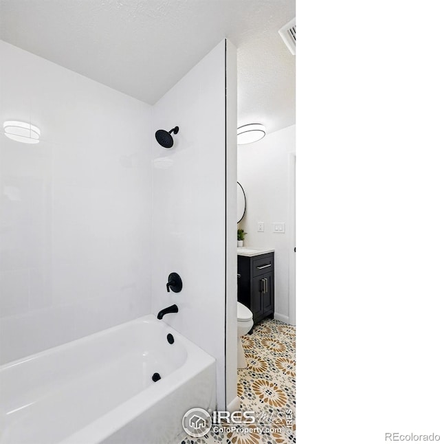 1805 W 22nd St, Loveland, CO 80538 - bathroom with vanity, tub / shower combination, toilet, and tile patterned floors