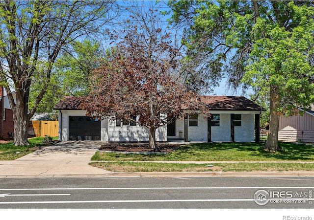 1805 W 22nd St, Loveland, CO 80538 - view of property hidden behind natural elements featuring driveway and a garage