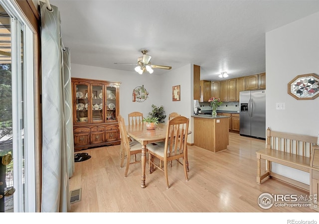 dining room with light wood-style floors and ceiling fan