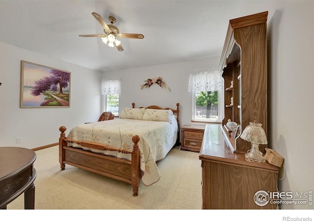 carpeted bedroom with a ceiling fan and baseboards