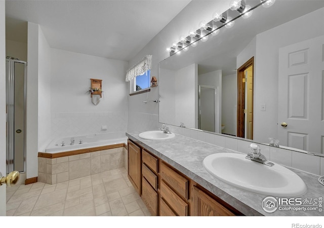 bathroom with a stall shower, a garden tub, double vanity, and tile patterned flooring