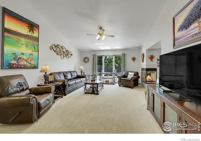 carpeted living area featuring a ceiling fan and a multi sided fireplace