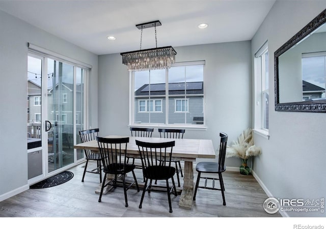 12917 Fox St, Broomfield, CO 80020 - dining room featuring wood finished floors, baseboards, recessed lighting, and a chandelier