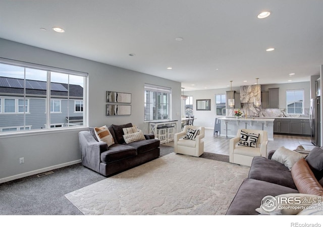 12917 Fox St, Broomfield, CO 80020 - living area with recessed lighting, light colored carpet, and baseboards