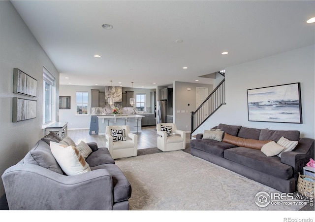 12917 Fox St, Broomfield, CO 80020 - living area with recessed lighting, stairs, light wood-style flooring, and baseboards