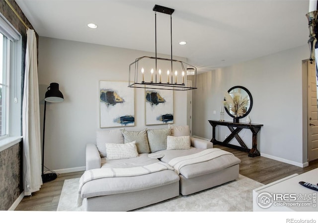 12917 Fox St, Broomfield, CO 80020 - living area featuring wood finished floors, a chandelier, plenty of natural light, and recessed lighting