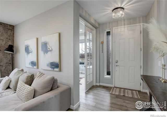 12917 Fox St, Broomfield, CO 80020 - entrance foyer featuring wood finished floors, baseboards, and a chandelier