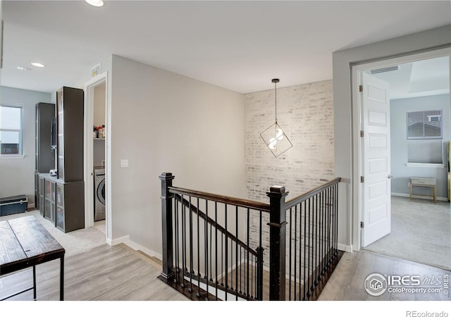 12917 Fox St, Broomfield, CO 80020 - hall with washer / clothes dryer, an upstairs landing, wood finished floors, baseboards, and recessed lighting