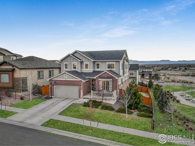 12917 Fox St, Broomfield, CO 80020 - view of front of house featuring board and batten siding, fence, concrete driveway, brick siding, and roof with shingles