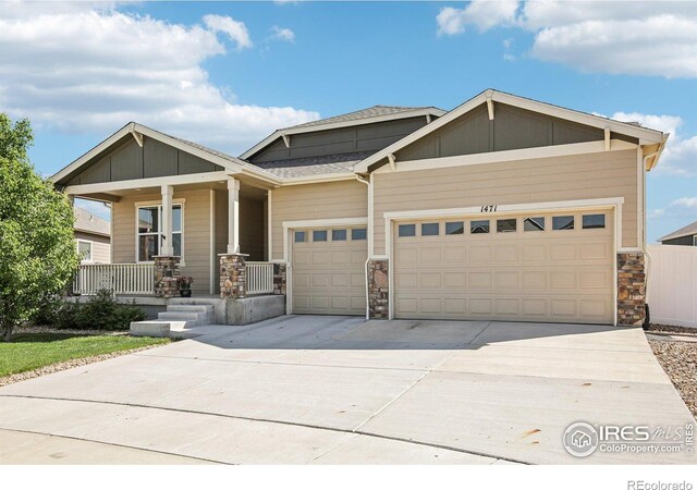 1471 Sabin Ct, Berthoud, CO 80513 - craftsman-style house with a garage, stone siding, concrete driveway, and a porch