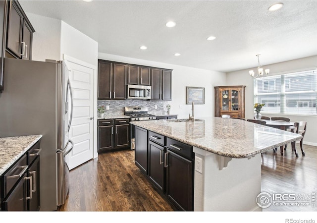 1471 Sabin Ct, Berthoud, CO 80513 - kitchen featuring appliances with stainless steel finishes, a sink, a chandelier, dark wood-style floors, and recessed lighting