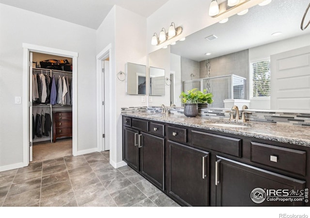 1471 Sabin Ct, Berthoud, CO 80513 - full bath with a shower stall, double vanity, a spacious closet, and baseboards
