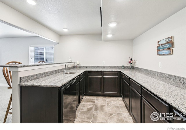 1471 Sabin Ct, Berthoud, CO 80513 - kitchen featuring a sink, a peninsula, light stone countertops, a textured ceiling, and recessed lighting