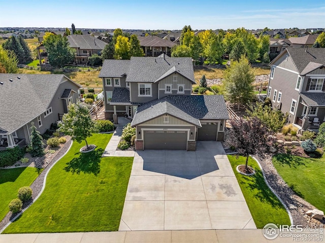 8265 Blackwood Dr, Windsor, CO 80550 - view of front of house featuring a residential view, a garage, a shingled roof, and driveway