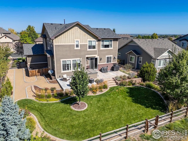8265 Blackwood Dr, Windsor, CO 80550 - back of property featuring board and batten siding, a patio area, and a residential view