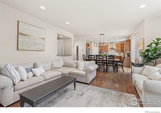 8265 Blackwood Dr, Windsor, CO 80550 - living room with recessed lighting, dark wood finished floors, and a chandelier