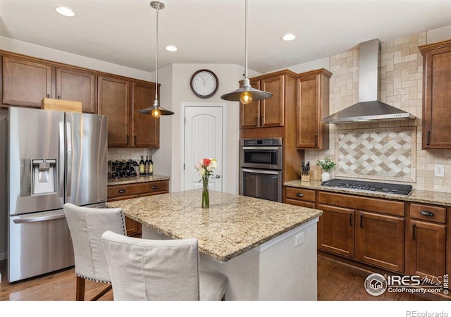8265 Blackwood Dr, Windsor, CO 80550 - kitchen with stainless steel appliances, wall chimney exhaust hood, a kitchen island, backsplash, and dark wood-style floors