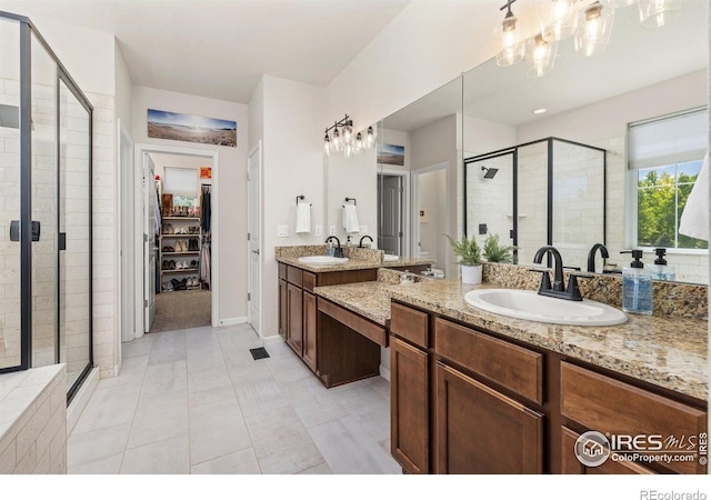 8265 Blackwood Dr, Windsor, CO 80550 - bathroom with a shower stall, a chandelier, two vanities, tile patterned flooring, and a spacious closet
