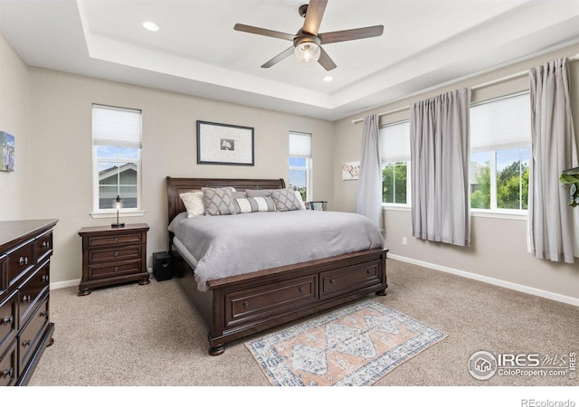 8265 Blackwood Dr, Windsor, CO 80550 - bedroom featuring a raised ceiling, light carpet, baseboards, and recessed lighting