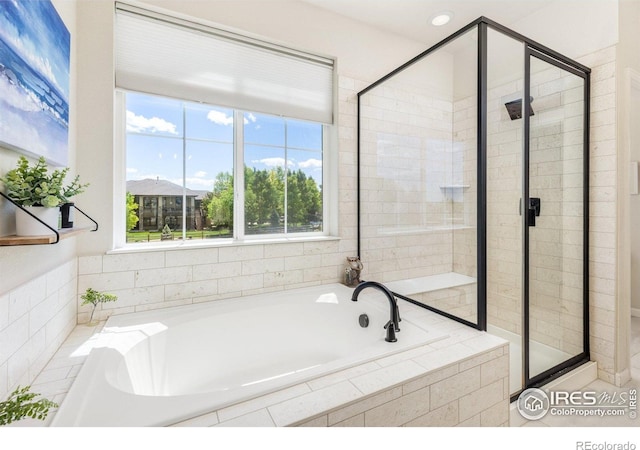 8265 Blackwood Dr, Windsor, CO 80550 - bathroom featuring a stall shower, a bath, and healthy amount of natural light