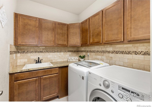 8265 Blackwood Dr, Windsor, CO 80550 - laundry area featuring washing machine and dryer and cabinet space