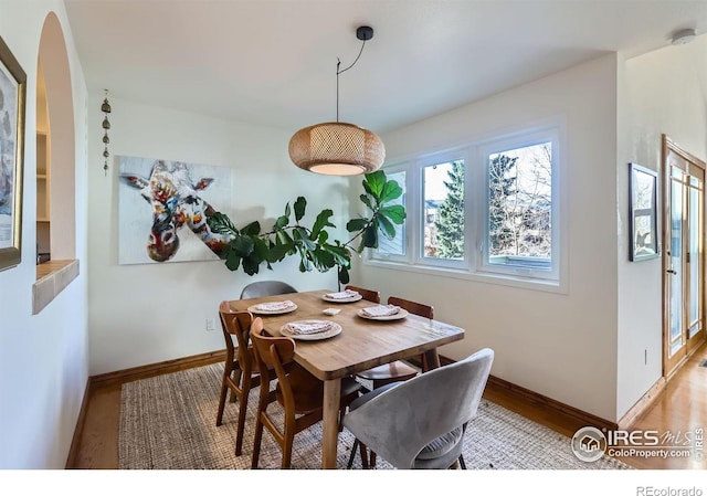 1149 Quince Ave, Boulder, CO 80304 - dining area with baseboards, light wood finished floors, and arched walkways