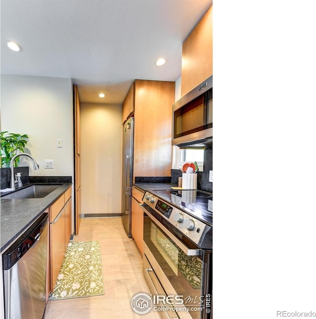 3025 Broadway St Unit 10, Boulder, CO 80304 - kitchen with stainless steel appliances, a sink, light wood-style flooring, recessed lighting, and a textured ceiling