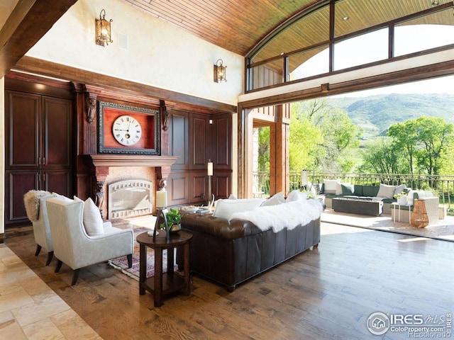 9840 Buckhorn Rd, Loveland, CO 80538 - living room with wooden ceiling, high vaulted ceiling, a glass covered fireplace, a mountain view, and dark wood-style floors
