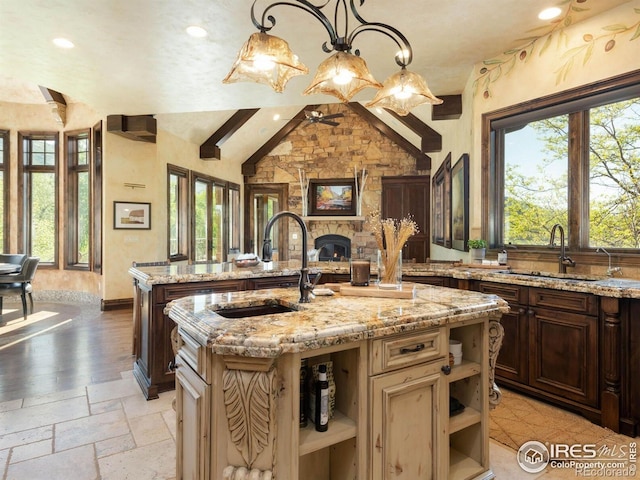 9840 Buckhorn Rd, Loveland, CO 80538 - kitchen featuring open shelves, a sink, an island with sink, plenty of natural light, and recessed lighting