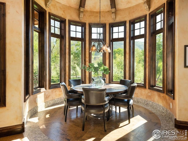 9840 Buckhorn Rd, Loveland, CO 80538 - sunroom / solarium with baseboards, plenty of natural light, a towering ceiling, a chandelier, and beam ceiling