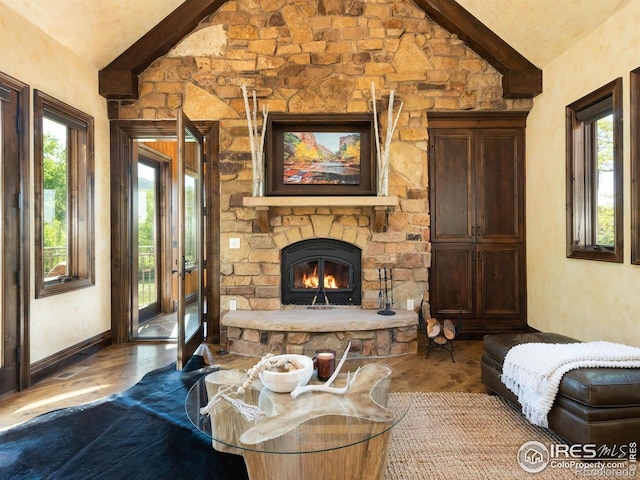 9840 Buckhorn Rd, Loveland, CO 80538 - living room featuring wood finished floors, plenty of natural light, a stone fireplace, and baseboards
