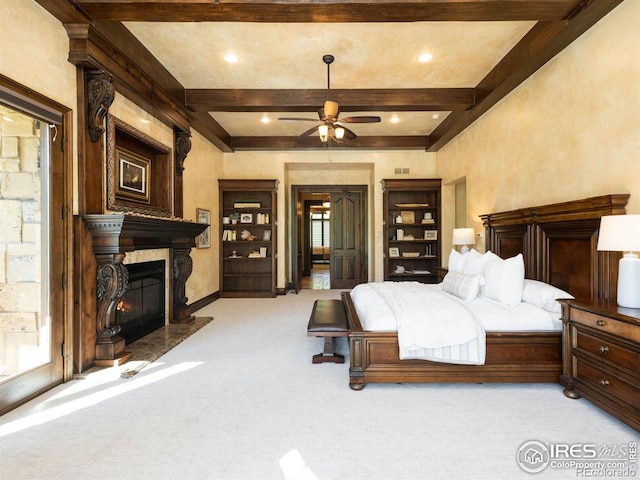 9840 Buckhorn Rd, Loveland, CO 80538 - bedroom with light colored carpet, beamed ceiling, a fireplace with flush hearth, baseboards, and recessed lighting