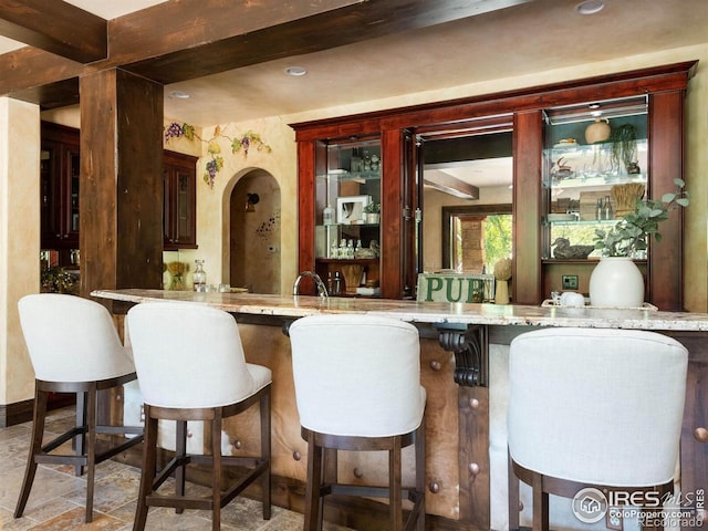 9840 Buckhorn Rd, Loveland, CO 80538 - indoor wet bar with stone finish flooring and beamed ceiling