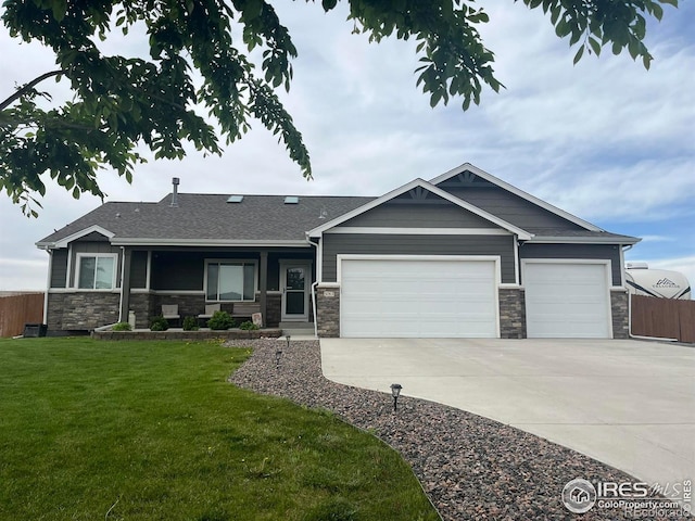 view of front of home with stone siding, a garage, driveway, and a shingled roof