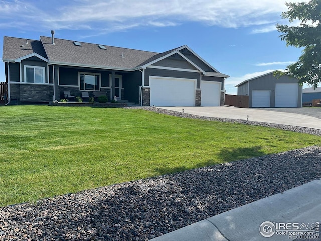ranch-style house featuring stone siding, a front yard, an attached garage, roof with shingles, and concrete driveway