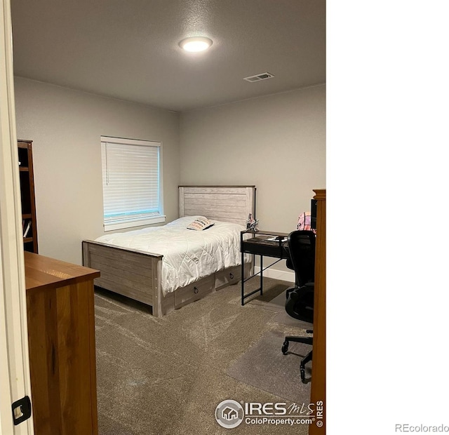 bedroom featuring carpet and an office area