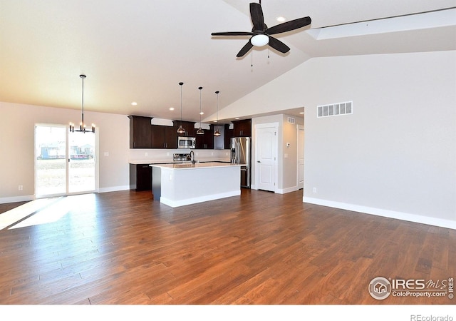 kitchen featuring open floor plan, stainless steel appliances, light countertops, a center island with sink, and a ceiling fan