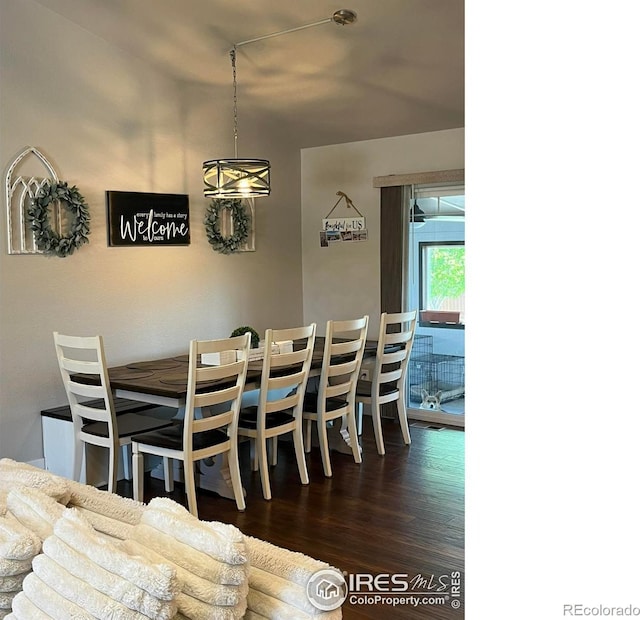 dining space featuring dark wood-style flooring