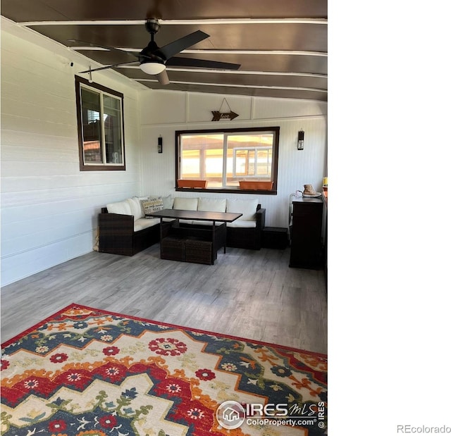living area featuring wood finished floors and ceiling fan