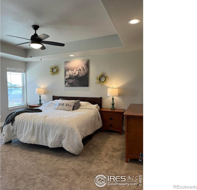 bedroom with carpet floors, a tray ceiling, recessed lighting, and ceiling fan
