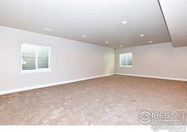 carpeted spare room with baseboards and recessed lighting